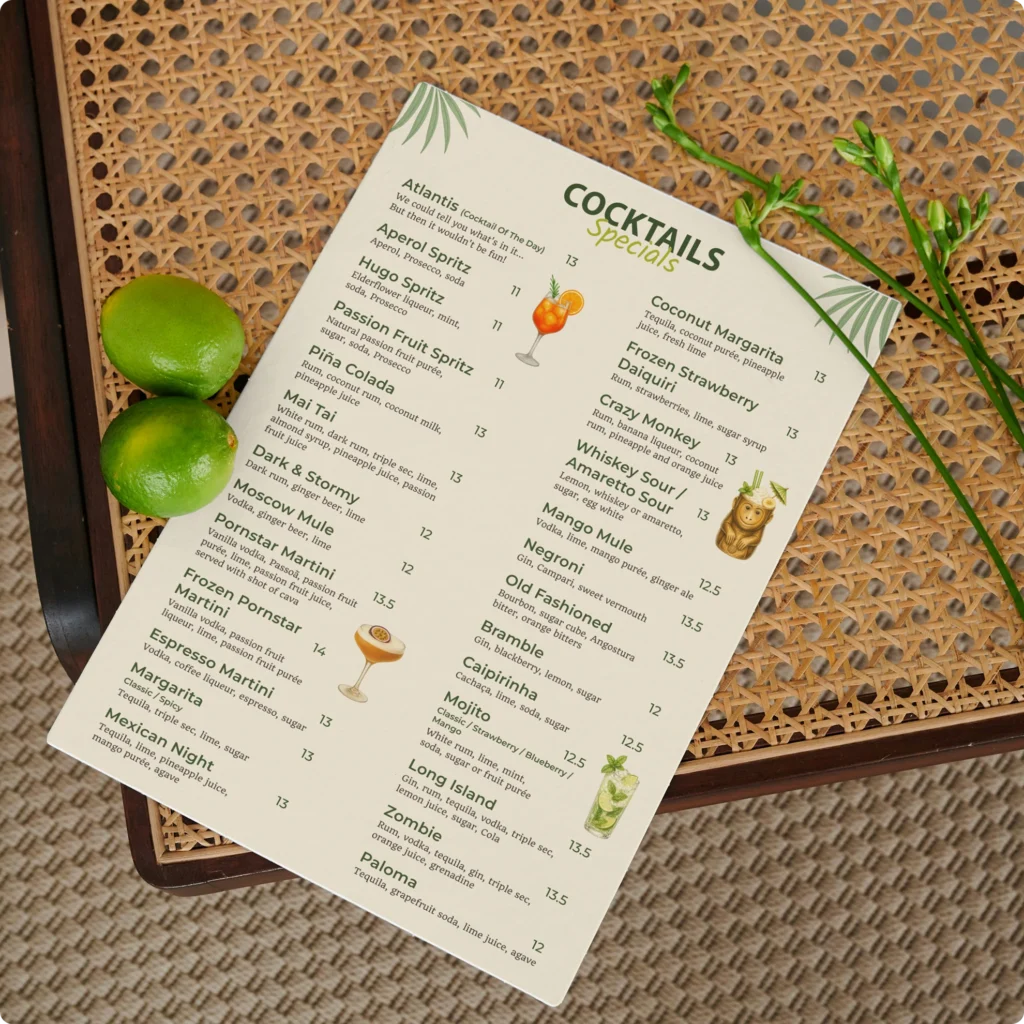 Cocktail menu design for Atlantis Cocktail Bar featuring signature cocktails, tropical illustrations, and a cream-colored layout.